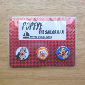 Three pin badges featuring Popeye the Sailor