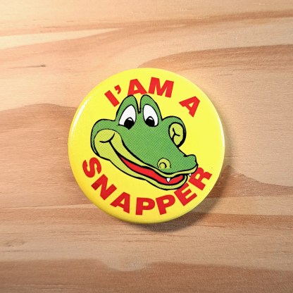 I am a snapper pin badge featuring a Crocodile