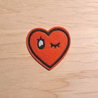 Iron-on patch featuring a winking red heart