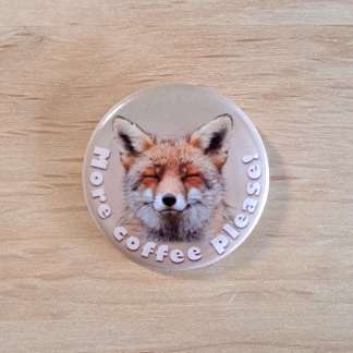 Pin badges and fridge magnets featuring a sleepy fox and the words, More coffee please