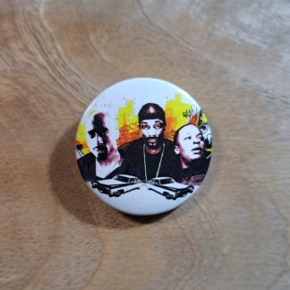 Pin badge featuring the musicians, Tupac, Dr Dre and Snoop Dogg