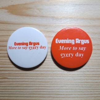 Two pin badges from the Evening Argus