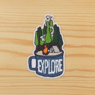 Iron-on embroidered patch featuring a camping scene inside a tin mug